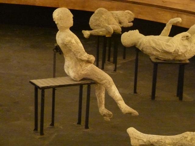VII.16.17-22 Pompeii. May 2012. Plaster cast of body lying at foot of staircase. Photo courtesy of Marina Fuxa.
