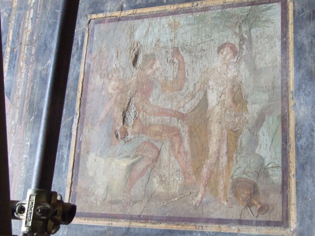 VII.16.17-22 Pompeii. December 2007. Wall painting from centre of east wall of oecus. Apollo sits on his throne, with a torch in his hand and a griffin on his throne. To his left is Venus with a cupid or Eros on her shoulder and a dove at her feet. To the right is Hesperus with a halo.
See Balch, D. L., 2008. Roman Domestic Art and Early House Churches. Tübingen, Germany: Mohr Siebeck. (p.160-2, Pl. 7). According to Grimaldi, this painting is of Apollo with Phaeton, Venus and cupid.
See Aoyagi M. and Pappalardo U. et al, 2006. Pompei (Regiones VI-VII) Insula Occidentalis. Napoli: Valtrend, (p.378)

