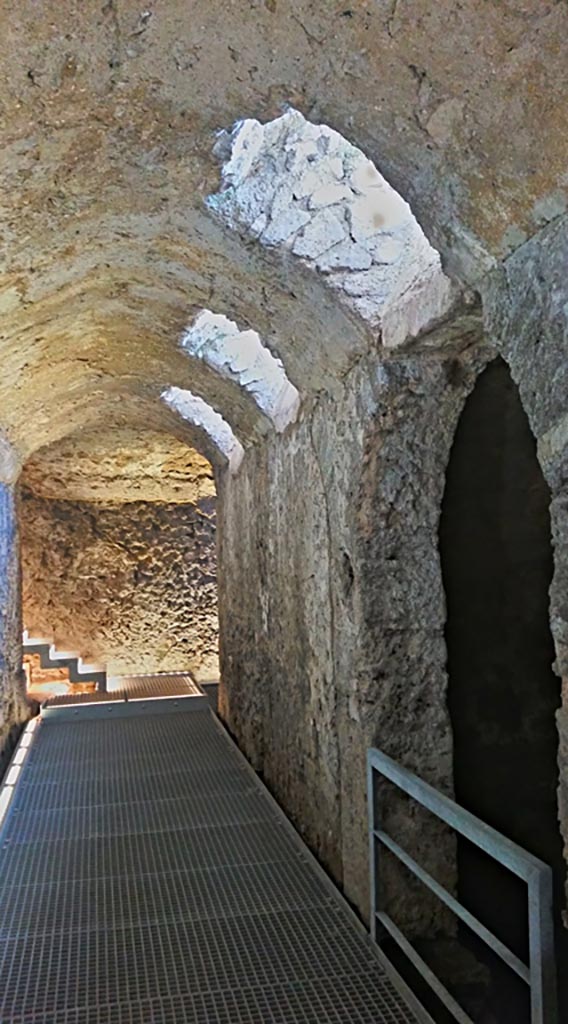 VIII.2.1 Pompeii. 2017/2018/2019.
Looking east from west end of corridor/cryptoporticus 25, with doorway to vaulted room 20 on south side.
Photo courtesy of Giuseppe Ciaramella.
