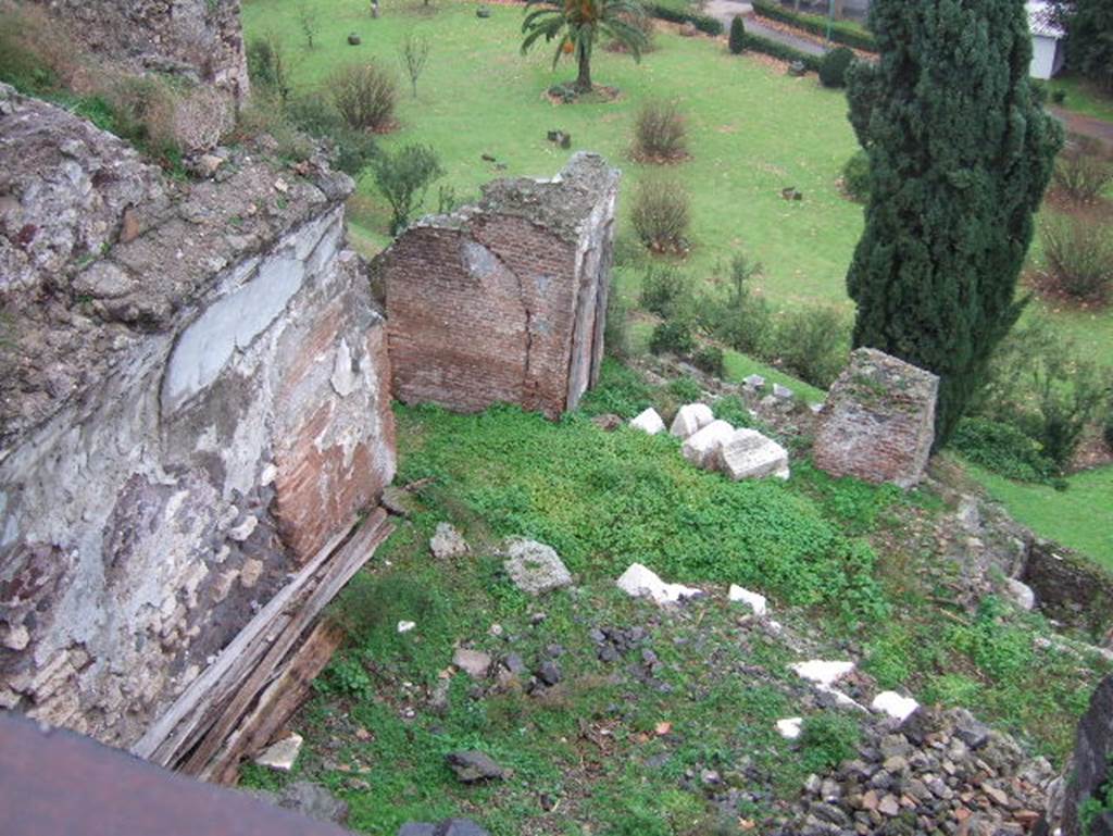 VIII.2.1 Pompeii. December 2005. 
Looking from south portico to lower floors which would have been under the terrace.  
According to PPM –
This photo is looking down onto the large triclinium (called “J”) which would have had a panoramic view to the south, the east wall is on the left.
According to PPM –
This would have had walls painted in the IV Style with a decorative scheme with partitions, not reconstructable as the plaster had fallen: 
the white background was also taken up into the vault, where some traces of squares with large rectangles remain.
See Carratelli, G. P., 1990-2003. Pompei: Pitture e Mosaici. VIII (8) Roma: Istituto della enciclopedia italiana, (p.55, no.53).
Looking ahead to area of cubiculum (θ) and triclinium (η).
According to PPM –
The work of liberation of the southern slopes of the city from the product of the eruption, following immediately after the war, had brought to light other rooms probably pertinent to this house.
In room (η), the north wall had a large window (?) looking into cubiculum (θ), and was decorated in II Style.
On the west side of this room “J” (on the right), would have been another large room, (called (К)  similar to large triclinium “J”), linked by a doorway.
