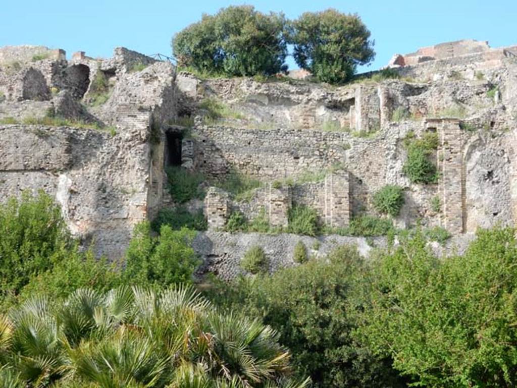 VIII.2.16 Pompeii. May 2015. 
Looking north towards lower floor levels beneath area of collapsed terrace garden. Photo courtesy of Buzz Ferebee.

According to Boyce, in a kind of cave beneath the court located behind the large atrium of number 16, on the extreme edge of the slope was a sacrarium of peculiar nature.
Against the rear wall of a narrow passage was built a masonry seat.
In the wall above it, a vaulted opening led into a small cell hewn out of the rock, with its floor 0.50m below that of the outer passage.
A second masonry seat was built within the cell, back to back with that in the outer passage.
The only means of entrance into this inner chamber appeared to have been over these two seats and through the small opening above them.
Within the cella stood a rectangular masonry altar and upon the altar lay a small terracotta altar, a marble ball, and two lamps decorated with reliefs.
One of the lamps was decorated with the relief of Jupiter, the other of a rose.
See Notizie degli Scavi di Antichit, 1890, 290.
See Boyce G. K., 1937. Corpus of the Lararia of Pompeii. Rome: MAAR 14. (p.74, no.344) 
See Giacobello, F., 2008. Larari Pompeiani: Iconografia e culto dei Lari in ambito domestico. Milano: LED Edizioni. (p.246)

