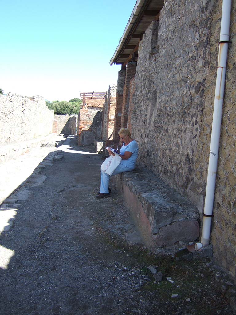 VIII.2.22 Pompeii. September 2005. Bench outside on west of doorway in Via della Regina.