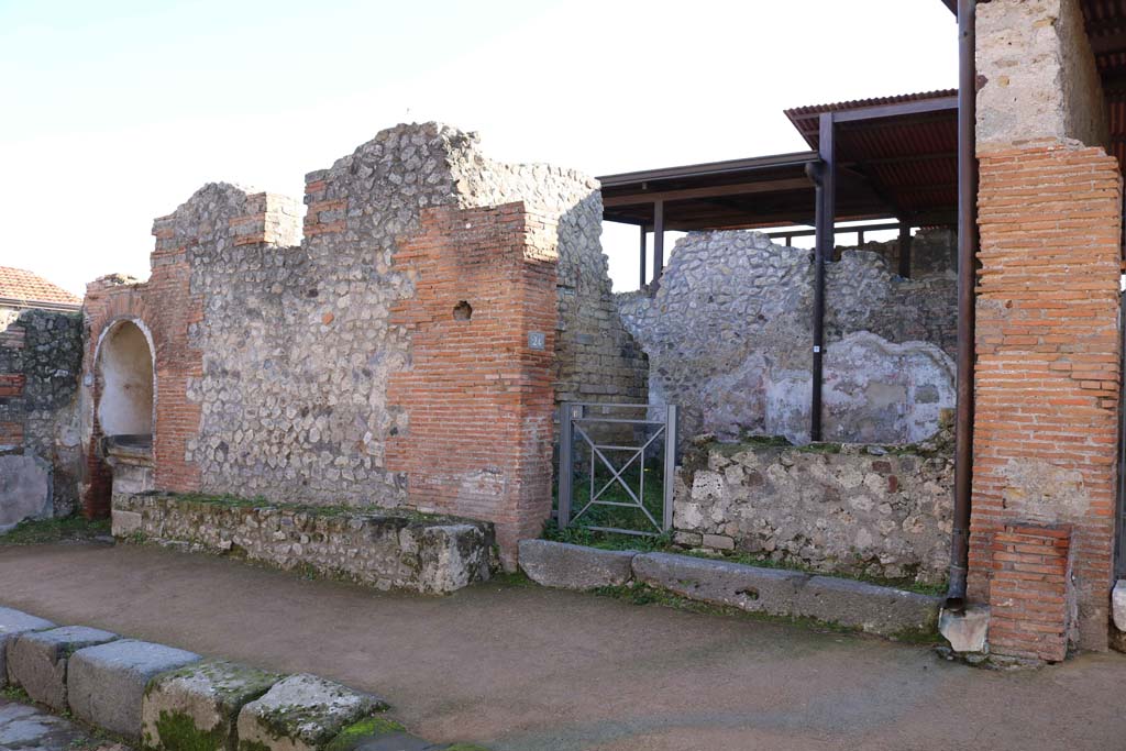VIII.2.24, Pompeii, on right, with altar at VIII.2.25, on left. December 2018. 
Looking towards entrances on south side of Via della Regina. Photo courtesy of Aude Durand.

