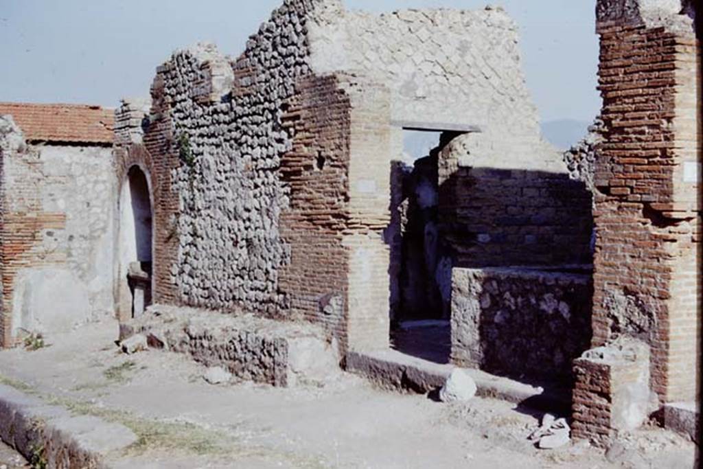 VIII.2.24 Pompeii. 1968. Looking east to entrance doorway, and bench outside near street shrine, on left.  Photo by Stanley A. Jashemski.
Source: The Wilhelmina and Stanley A. Jashemski archive in the University of Maryland Library, Special Collections (See collection page) and made available under the Creative Commons Attribution-Non Commercial License v.4. See Licence and use details.
J68f2334
