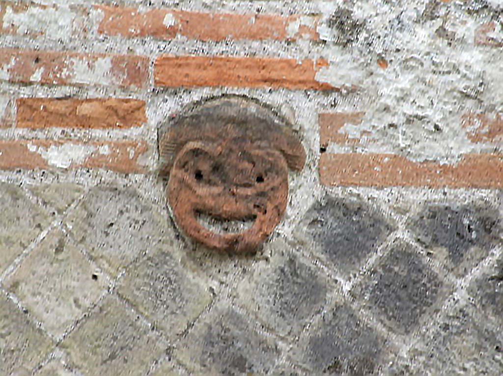 VIII.2.30 Pompeii. December 2006. Face on front wall on west side of entrance doorway.