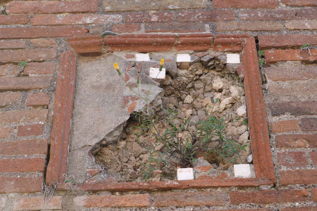 VIII.3.6 Pompeii, on left, and VIII.3.5, on right. December 2018. 
Detail of plaque on pilaster between doorways. Photo courtesy of Aude Durand.

