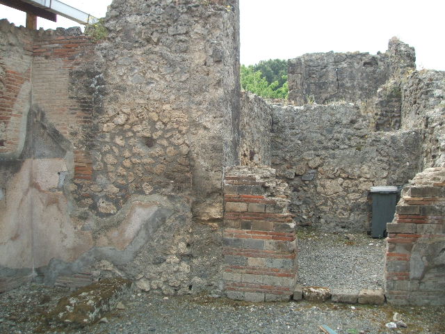 VIII.3.7 Pompeii. May 2005. South wall of shop, with doorway to rear room in south-west corner.