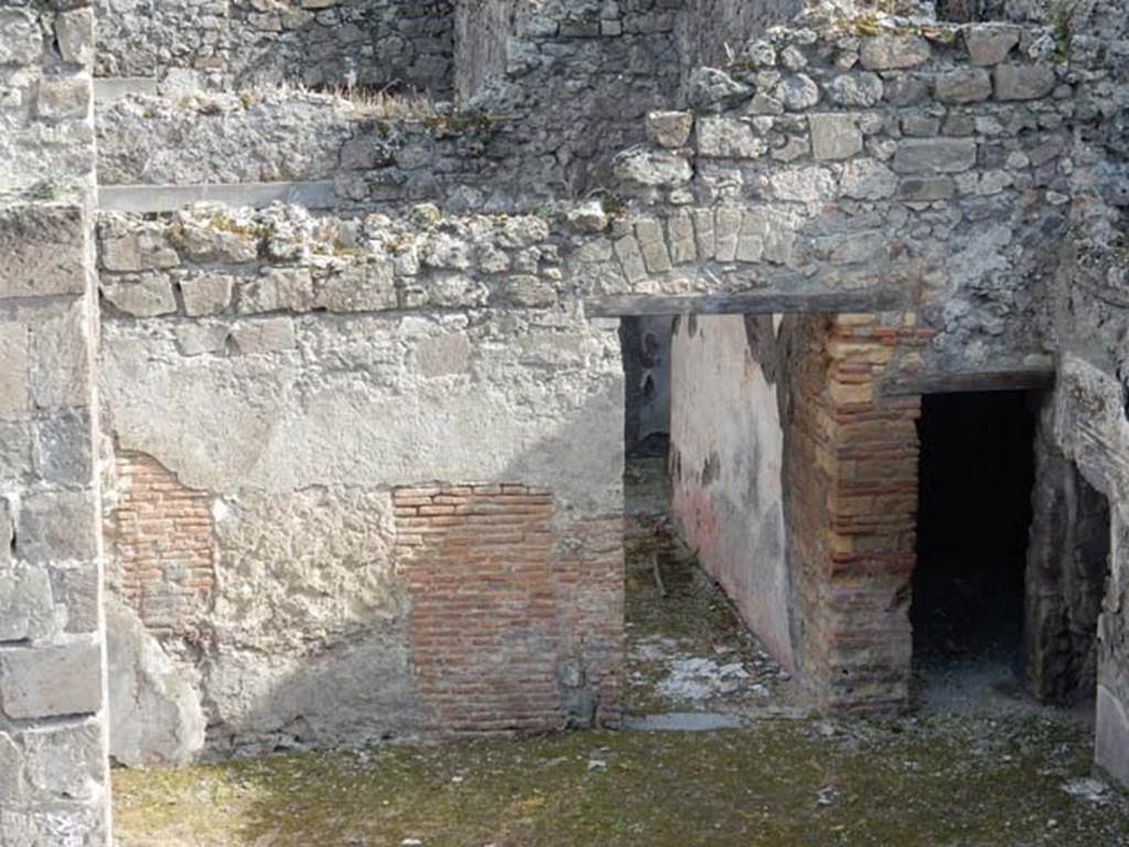VIII.3.11 Pompeii. May 2006. 
Doorway (centre) in south wall, leading into triclinium with window, and through doorway into courtyard near entrance at VIII.3.12.
