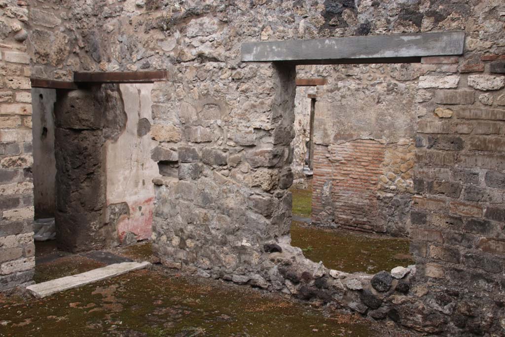 VIII.3.12 Pompeii. October 2020. Doorways on north-west side of entrance yard/courtyard
On the left, the doorway leading to a corridor across the triclinium leading to VIII.3.11 and window into triclinium. Photo courtesy of Klaus Heese.


