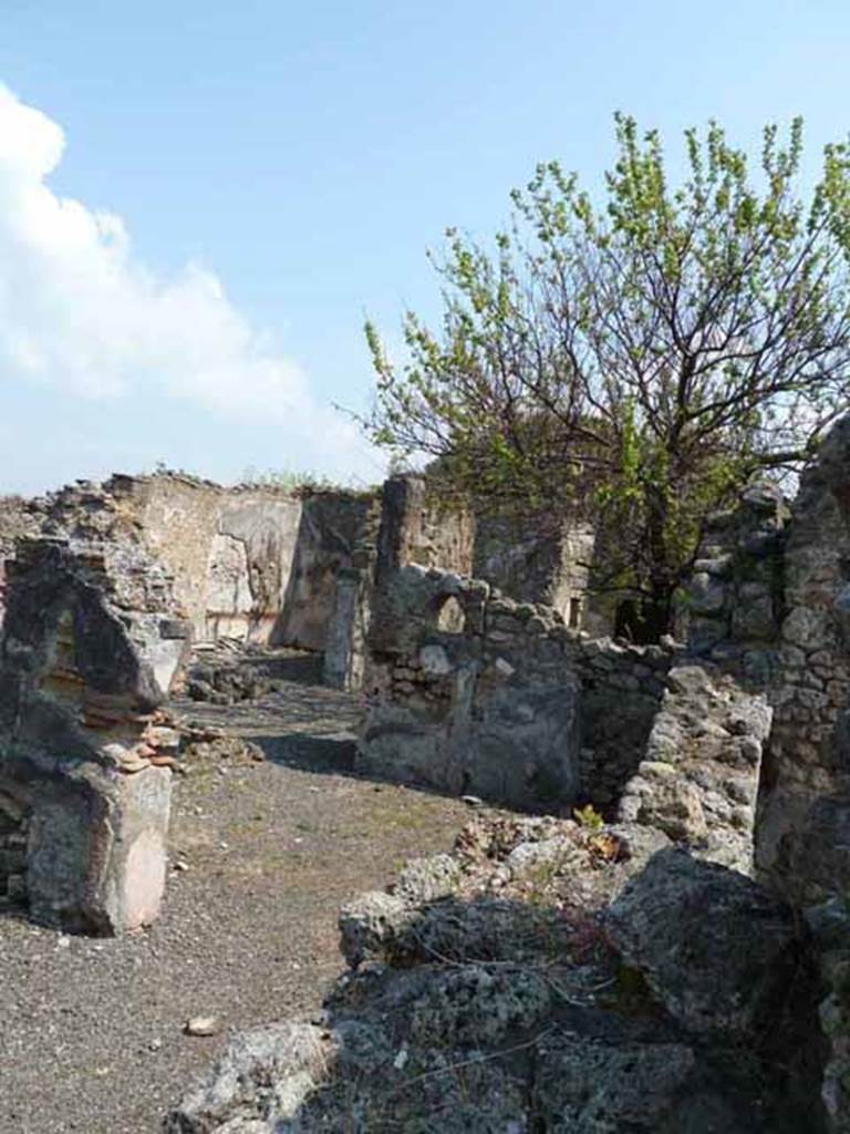 VIII.3.21 Pompeii. May 2010. Looking north-east to room 6 and rear of house.
According to Fiorelli, on the one column that supported a covered portico, the following graffito was found.
This gave the name of someone who had lived here –
Sex. Decimius Rufus milis coh V pr ? Martialis    [CIL IV 1994]
See Pappalardo, U., 2001. La Descrizione di Pompei per Giuseppe Fiorelli (1875). Napoli: Massa Editore. (p.125)

According to Epigraphik-Datenbank Clauss/Slaby (See www.manfredclauss.de) this read as –
Sex(tus)  Decimius  Rufus
mil(e)s  coh(ortis)  V  pr(aetoriae)  (centuria)  Martialis

According to Mau, this translated as –
Sextus Decimius Rufus, a soldier of the 5th praetorian cohort, of the century led by Martialis
See Mau, A., 1907, translated by Kelsey, F. W., Pompeii: Its Life and Art. New York: Macmillan. (p. 492).

