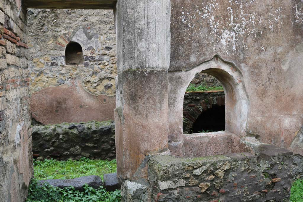 VIII.4.4, Pompeii. December 2018. 
Looking east to doorway to room 7, with square basin beneath arched opening, on the south side. Photo courtesy of Aude Durand.
