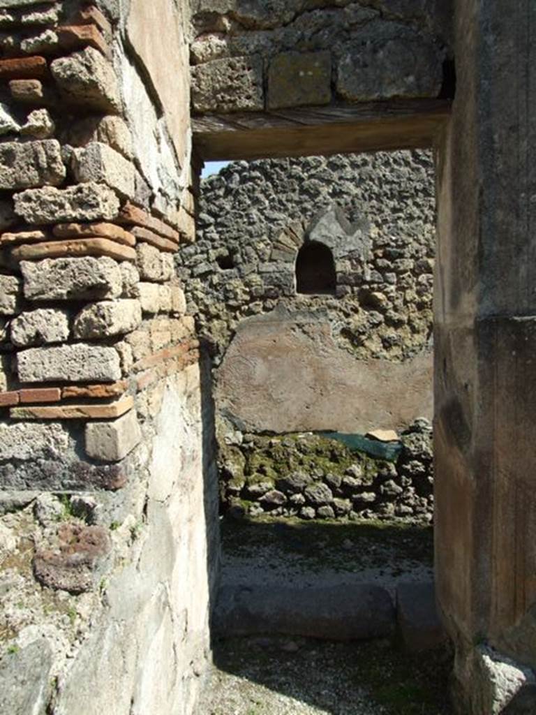 VIII.4.4 Pompeii. March 2009. Doorway to room 7, kitchen. Looking towards east wall with niche.