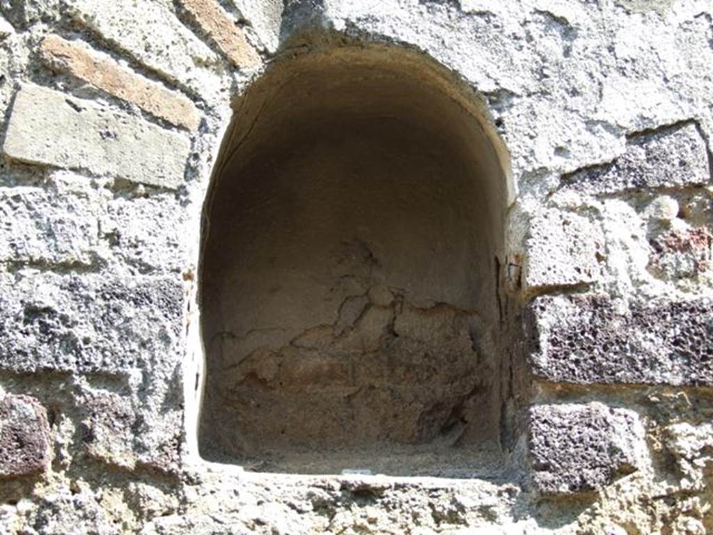 VIII.4.4 Pompeii. March 2009. Room 7, niche on east wall of kitchen.
According to Boyce, this small arched niche was above a masonry tub and adorned with an aedicula façade.
See Boyce G. K., 1937. Corpus of the Lararia of Pompeii. Rome: MAAR 14. (p.76) 
See Giacobello, F., 2008. Larari Pompeiani: Iconografia e culto dei Lari in ambito domestico.  Milano: LED Edizioni. (p.199)
