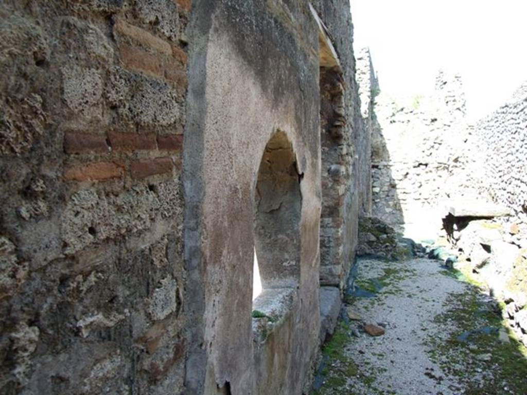 VIII.4.4 Pompeii.  March 2009.  Room 7.  Kitchen.  West wall with arched opening, connecting the kitchen to the basin in area 8.  