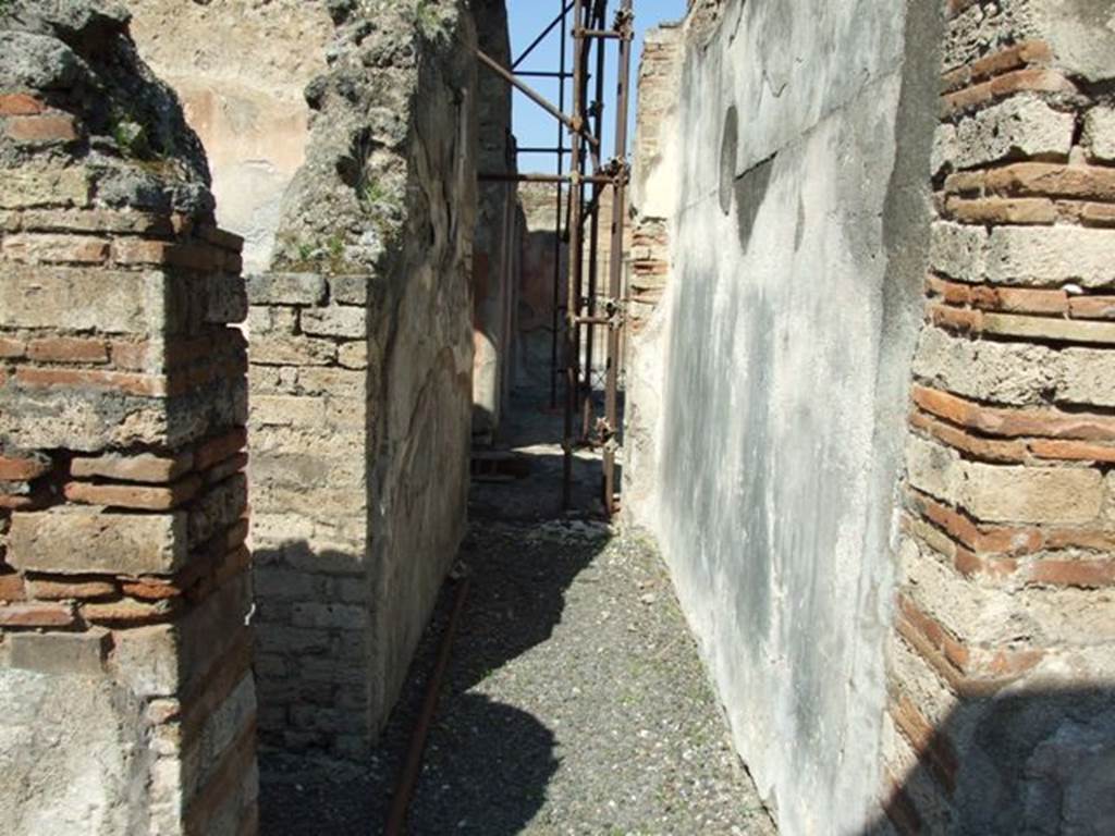 VIII.4.4 Pompeii. March 2009. Room 19, corridor or andron, looking north. According to PPM, on the east wall (on the right), a black zoccolo could be seen. The middle of the wall had red panels separated by narrow black compartments, and the upper wall was faded. 
In the panels of the middle zone were vignettes with IVth style painted animals.
