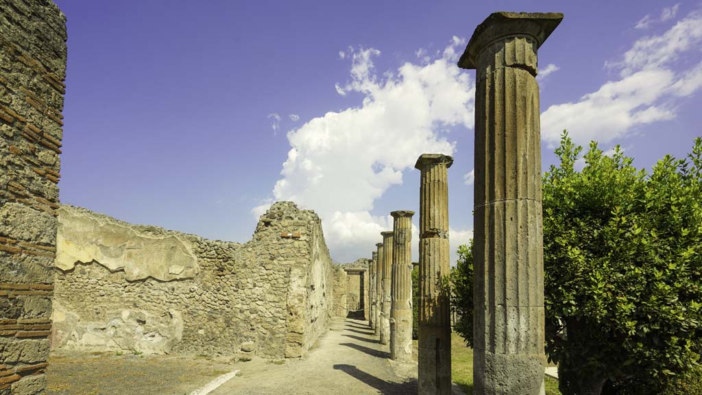 VIII.4.15 Pompeii. August 2021. Looking north along west portico, with doorway to exedra 17, on left. Photo courtesy of Robert Hanson.