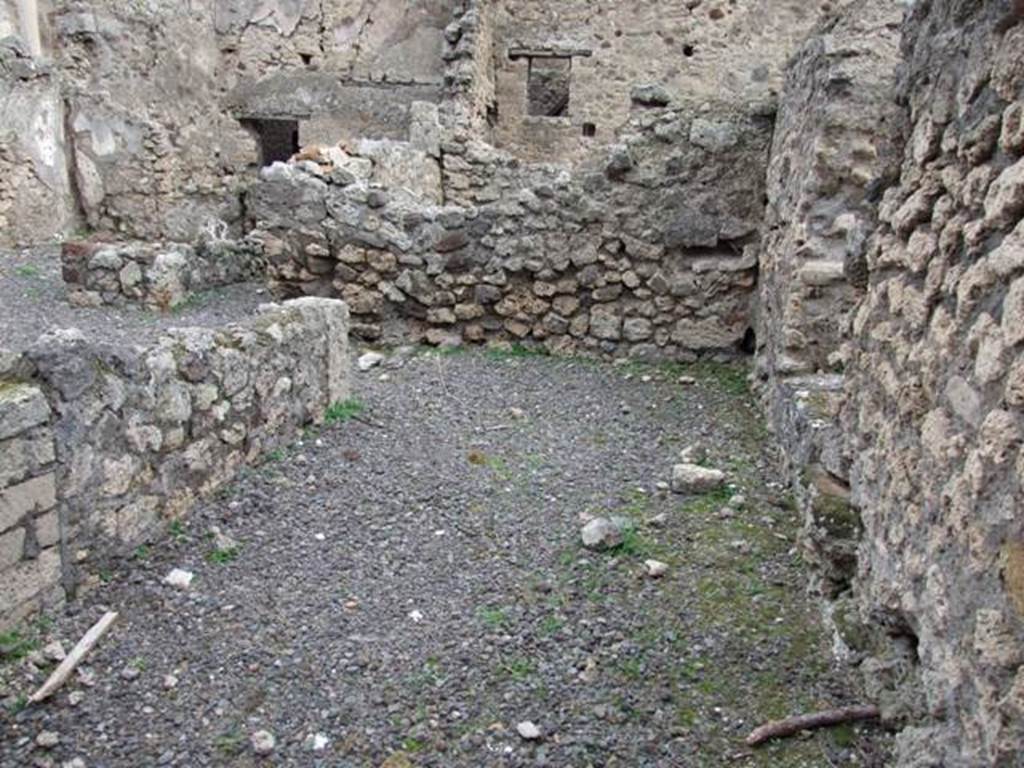 VIII.4.43 Pompeii. December 2007. East wall of shop, in centre of the picture. On the left can be seen the linked doorway throught to the corridor in VIII.4.44.
