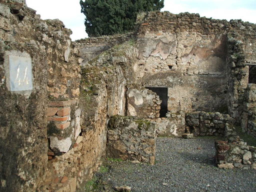 VIII.4.44 Pompeii. December 2004. Looking east across shop, behind which was the  triclinium.