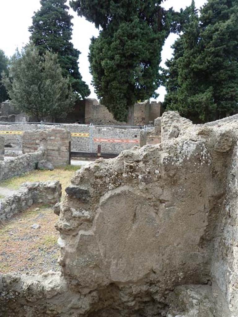 VIII.4.44 Pompeii. September 2015. Looking west into north-west corner of room at rear of triclinium.