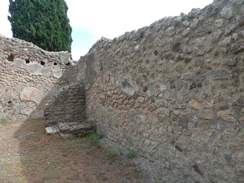 VIII.4.46 Pompeii. September 2015. Looking east towards base of steps in south-east corner of shop-room, and south wall