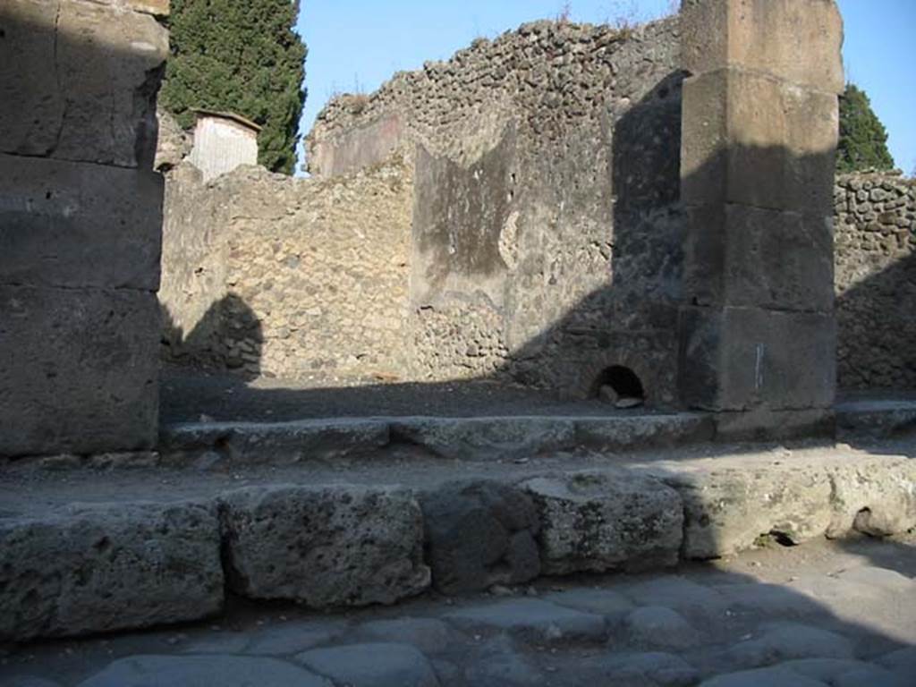 VIII.4.47 Pompeii. May 2003. Looking towards south-east corner of shop, with hearth against the south wall at the front, near entrance. Photo courtesy of Nicolas Monteix.
