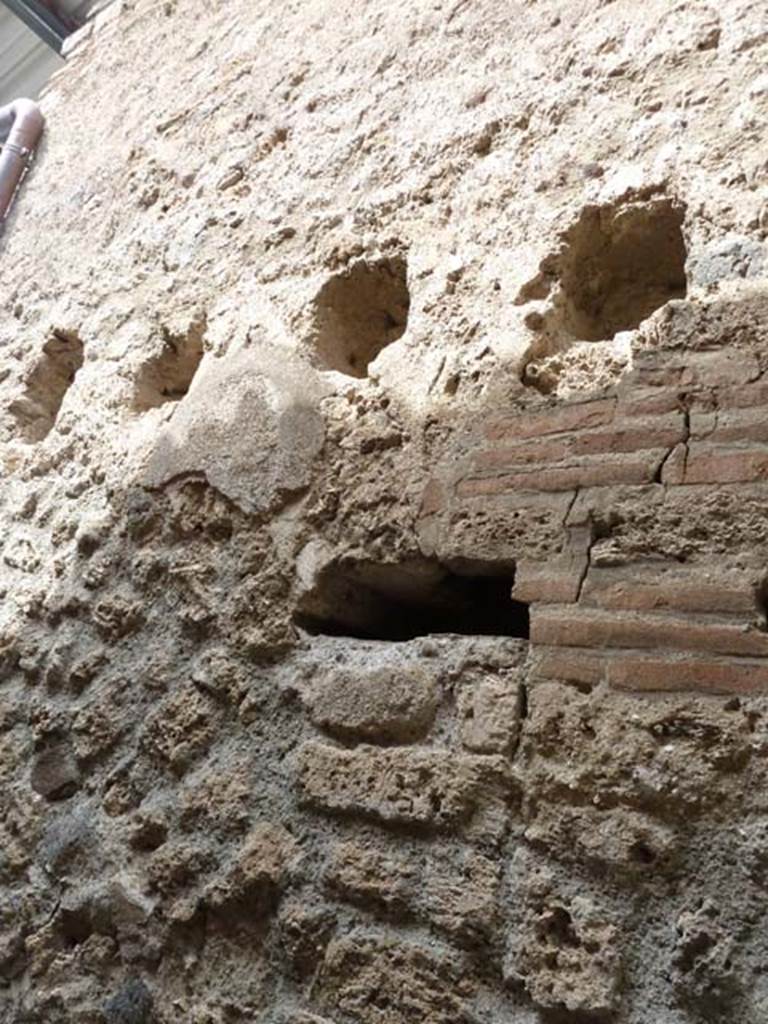 VIII.4.49 Pompeii. September 2015. Detail of holes for support beams for upper floor in corridor.