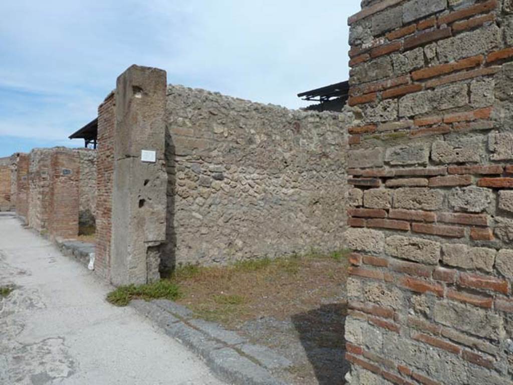 VIII.4.50 Pompeii. September 2015. Looking north to entrance doorway on east side of Via dei Teatri.