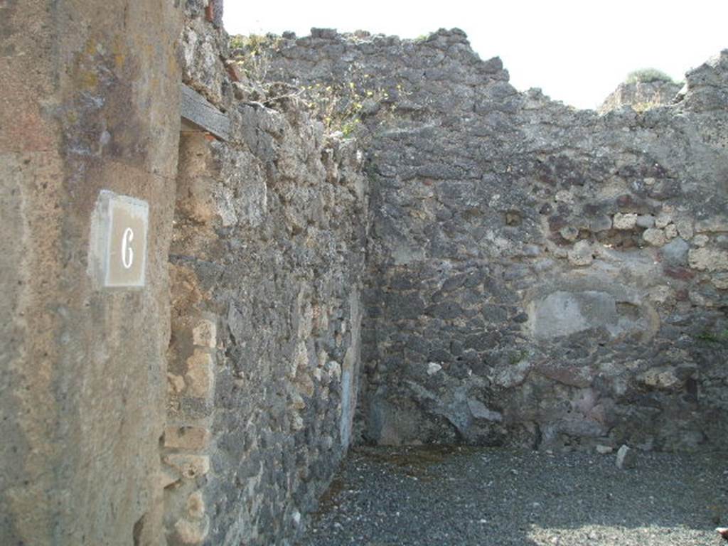 VIII.5.6 Pompeii. May 2005. East wall with communicating doorway to VIII.5.7, and south wall.  According to Hobson, a wall scar of a down-pipe can be seen in the south-east corner of the shop. See Hobson, B., 2009. Pompeii, Latrines and Down Pipes. Oxford, Hadrian Books. (p.460).  
