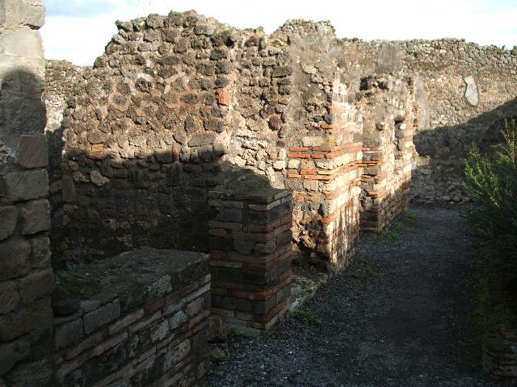 VIII.5.24 Pompeii. December 2004. Looking east along north portico, with doorways to rooms 10,9 and 8.