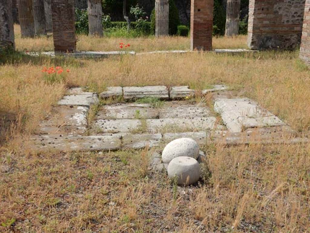 VIII.5.28 Pompeii. May 2017. Room 1, stone ball and weight in atrium. Photo courtesy of Buzz Ferebee.
