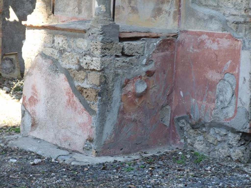 VIII.5.37 Pompeii.  March 2009.  South side of Podium of Lararium, with remains of painted plant decoration.
