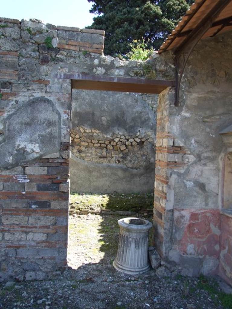 VIII.5.37 Pompeii.  March 2009. Doorway to Room 5, Ala, with marble puteal.
