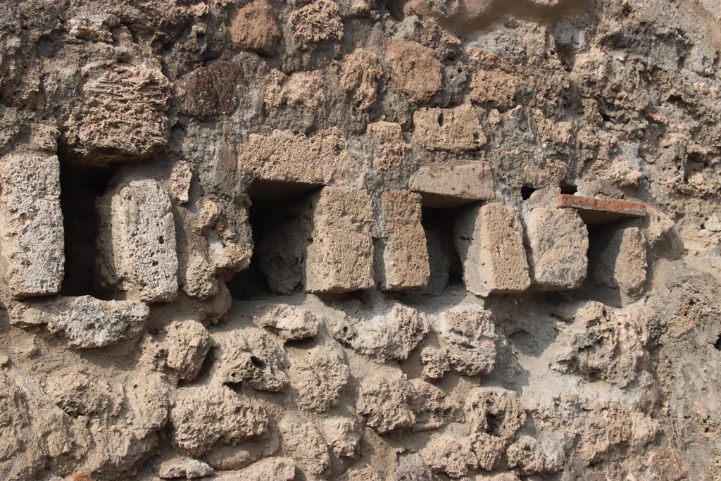 VIII.6.3 Pompeii. October 2023. 
Room (b), detail from upper west wall of holes for support beams for an upper floor. Photo courtesy of Klaus Heese.
