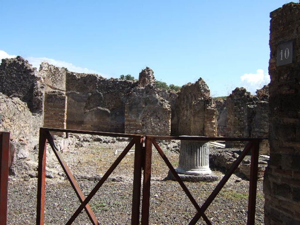 VIII.6.10 Pompeii. September 2005. Looking east from entrance into area of peristyle.
According to Mau, the dwelling of the owner of the bakery was placed around the peristyle.
It had a separate entrance doorway from the western roadway, preceded by a step covered with roof tiles, one of which had a stamp mark. See BdI, 1884, p.182.

According to Jashemski, the area was not a garden but had a pavement of opus signinum.
The area was enclosed on all four sides by a portico, supported by three columns on the north and south. The columns were painted black below, and red above. Today, only the bases of the columns remain. In the middle of the paved area, according to the reports, there was a rectangle lined with pieces of white and grey marble, in which pieces of yellow marble formed a cross. In the centre of the cross was a little yellow square bordered by a narrow red stripe.  Today it is much damaged. The various rooms of the house opened off the portico, which could be entered directly from the street at VIII.6.9.  The atrium at the front of the house had been converted into a bakery, VIII.6.1.
See Jashemski, W. F., 1993. The Gardens of Pompeii, Volume II: Appendices. New York: Caratzas. (p.219)
