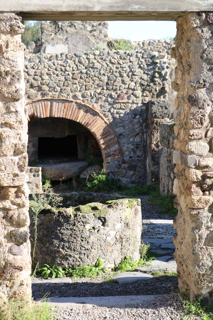 VIII.6.11, Pompeii. December 2018. 
Looking east through doorway from room “f” or stable, towards bakery. Photo courtesy of Aude Durand.
