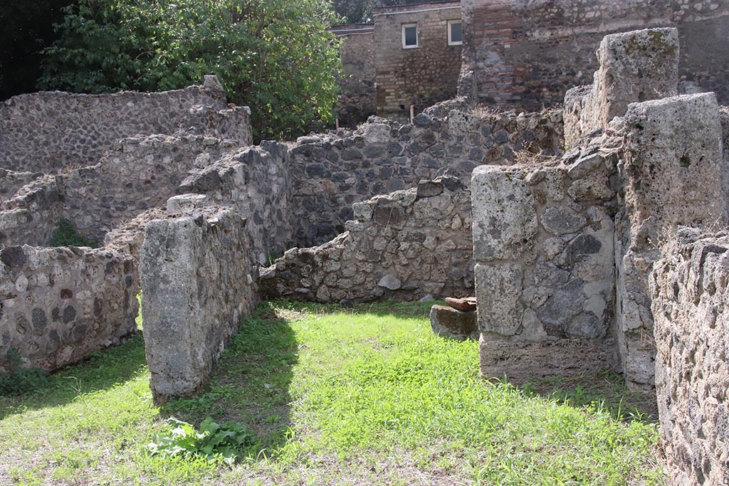 VIII.7.10 Pompeii. October 2024. Looking west across shop towards room at rear. Photo courtesy of Klaus Heese.