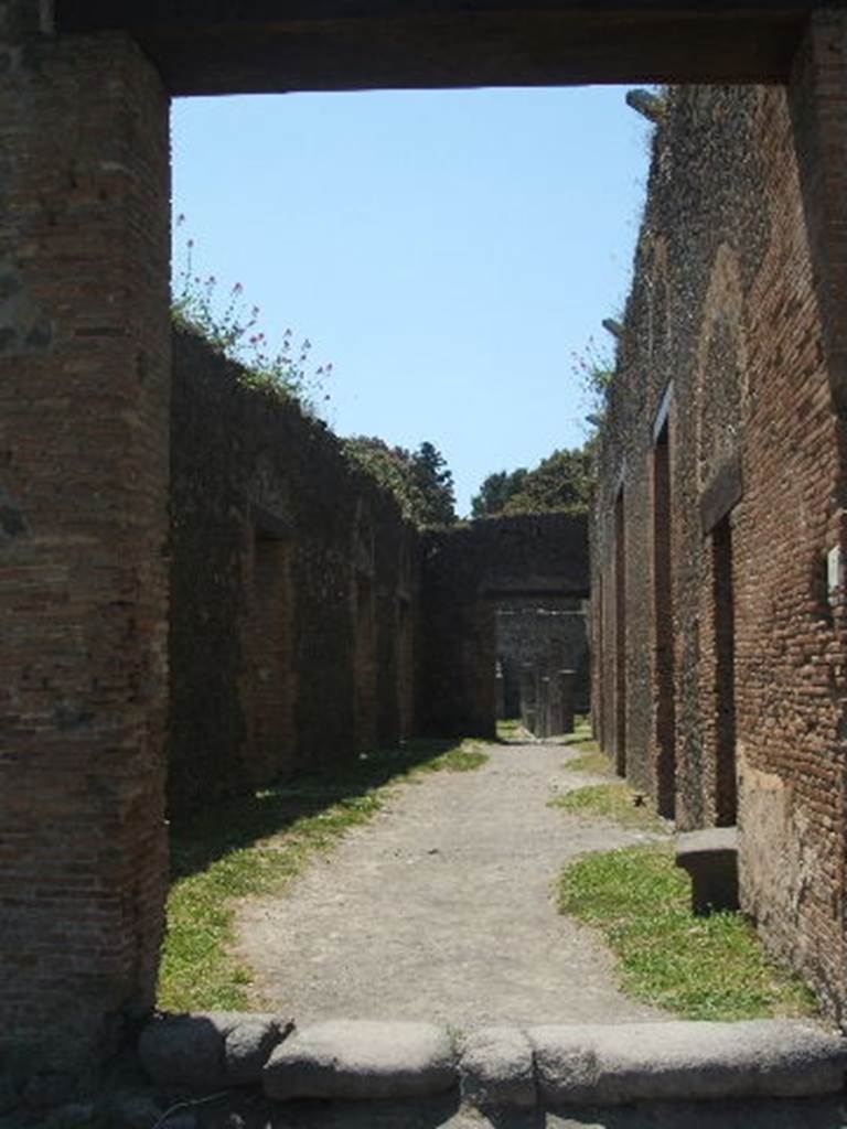 VIII.7.17 Pompeii, centre left, and VIII.7.16, on right. December 2018. 
Looking east from north-east corner of Gladiators’ Barracks. Photo courtesy of Aude Durand.

