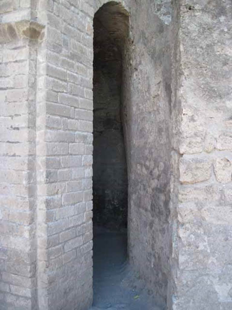 VIII.7.21 Pompeii. September 2010. Entrance way to the latrine. The latrine entrance is located to the left of the stairs leading to the summa cavea of the large theatre. This is between the triangular forum and the principal access door to the theatre crypta. Photo courtesy of Drew Baker.

