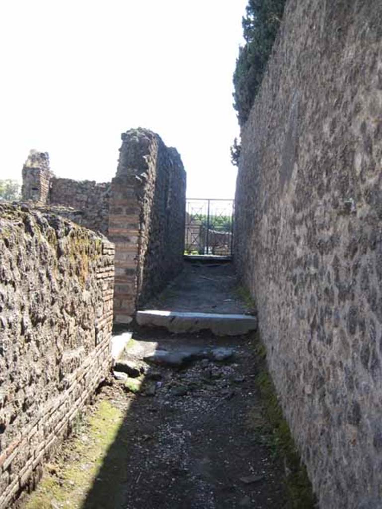VIII.7.27 Pompeii. September 2010. Mid way in passage, looking south towards theatre. VIII.7.27A is on left of image by marble step. Photo courtesy of Drew Baker.
