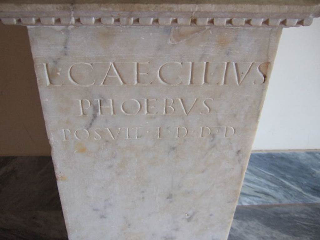 VIII.7.28 Found in Temple of Isis or Tempio di Iside on 4th March 1766. 
Marble pedestal from under statue of Isis with inscription recording its donation.
Now in Naples Archaeological Museum. Inventory number 9976.
L(VCIVS) CAECILIVS PHOEBVS POSVIT
L(OCO) D(ATO) D(ECRETO) D(ECVRIONVM)       [CIL X 849]
According to Cooley this translates as 
Lucius Caecilius Phoebus erected (this statue); space granted by decree of the town councillors.
See Cooley, A.E. and M.G.L., 2004, Pompeii, A Sourcebook, London and New York, Routledge, p. 87, no. E5.

