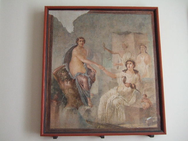 VIII.7.28 Pompeii. Arrival of Io, still horned, but now in the care of a sea deity, at Canopus. 
Isis offers her hand as her priestesses shake their sistra. 
Found in the centre of the south wall of the Ekklesiasterion in November 1765. 
Now in Naples Archaeological Museum. Inventory number 9558.

