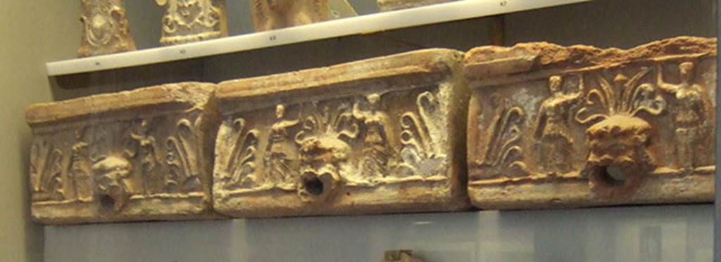 VIII.7.28 Pompeii. Location unknown. Roof gutter with theatrical mask spouts surmounted by a palmette and with two female caryatids. Now in Naples Archaeological Museum. Inventory numbers 21613, 21614, 21615.