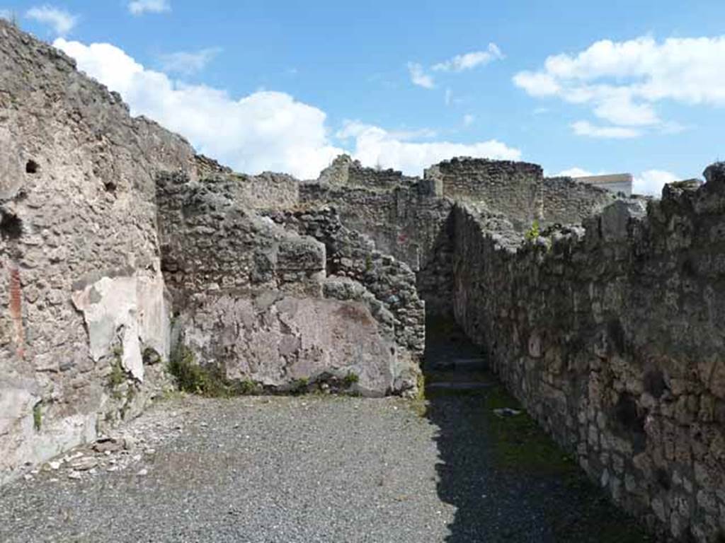 IX.1.1 Pompeii. May 2010.  East wall of shop, with site of latrine behind it.