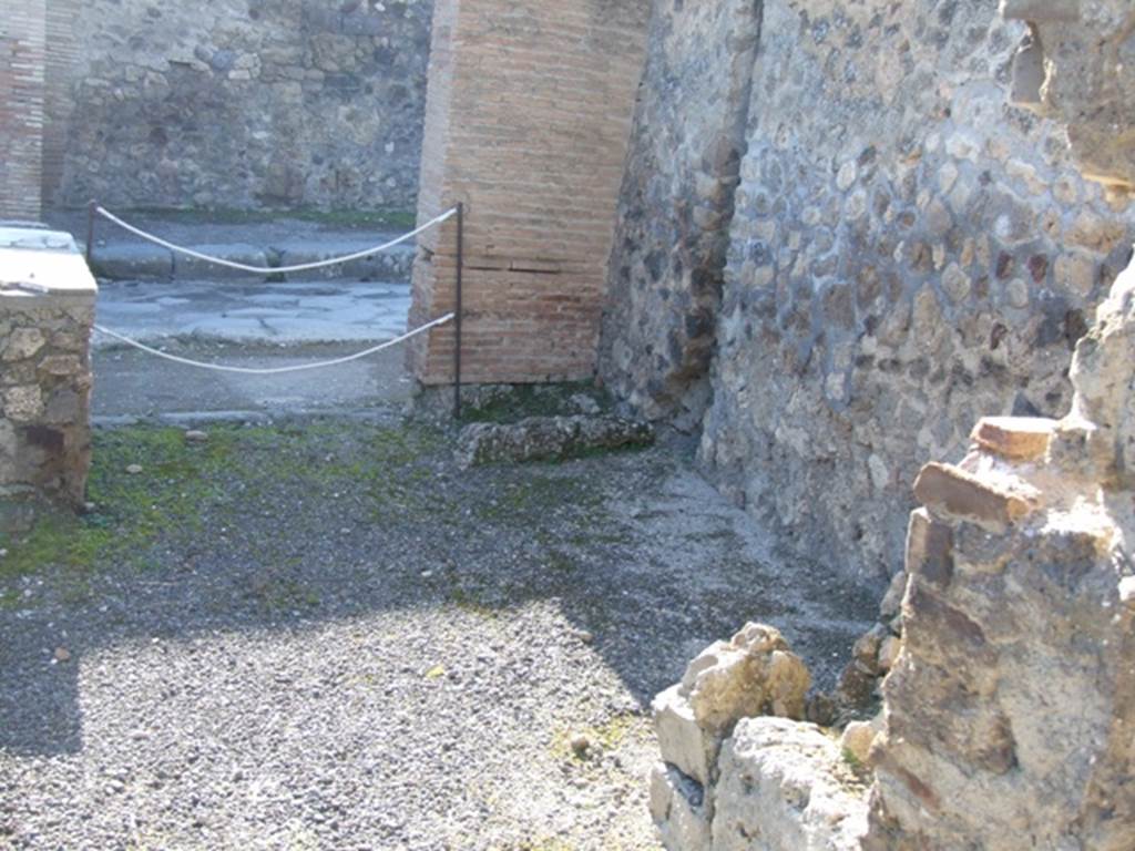 IX.1.6 Pompeii. March 2009. North wall with latrine in north-west corner by drainpipe.