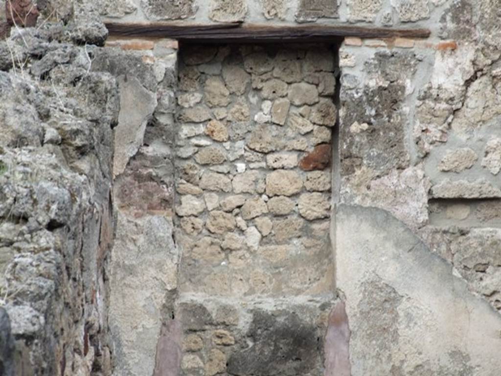 IX.1.8 Pompeii. December 2007. East wall with bricked-up window or recess in rear room.