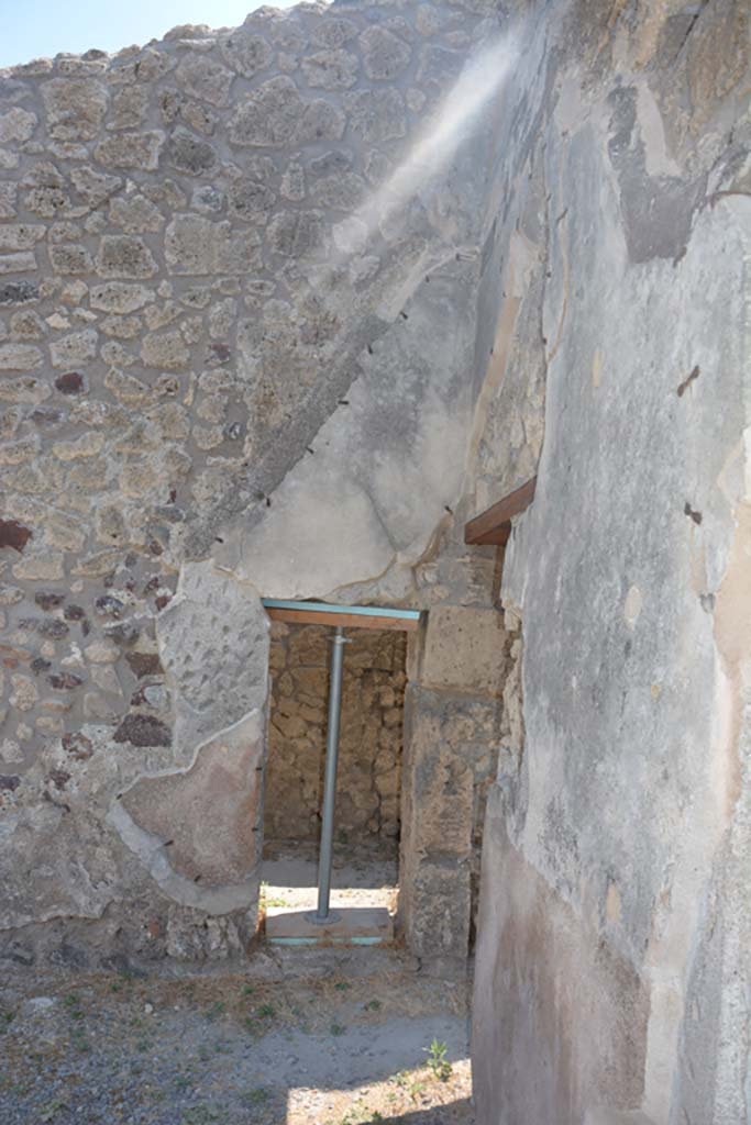IX.1.12 Pompeii. December 2007.  Small doorway in east wall of south east corner of atrium, leading to room with stairs of wood.


 
