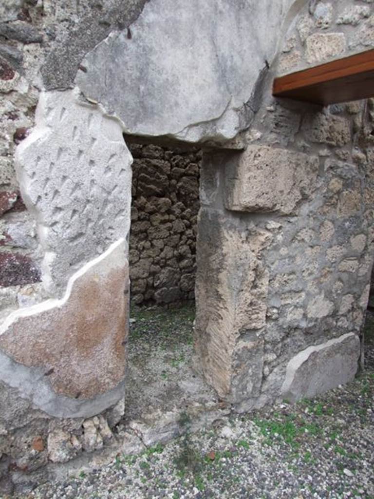 IX.1.12 Pompeii. December 2007. Small room that contained stairs of wood, on south side of portico, with small doorway into atrium.