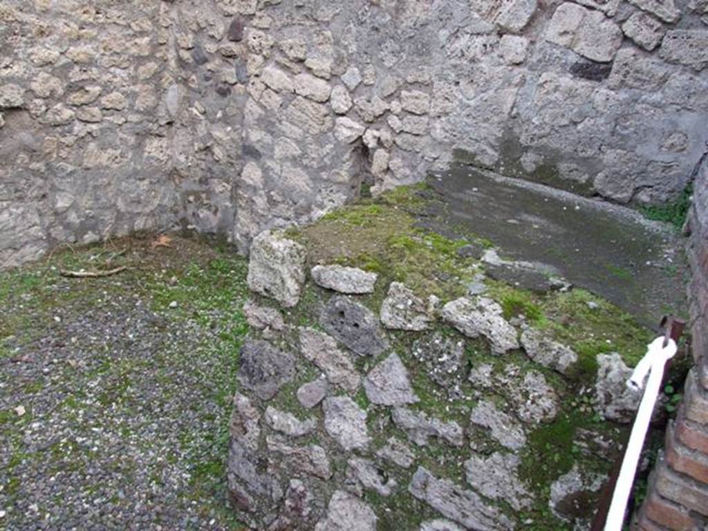 IX.1.13 Pompeii. December 2007. Hearth on south side of shop-room. At the rear were stairs to upper floor with latrine beneath. 