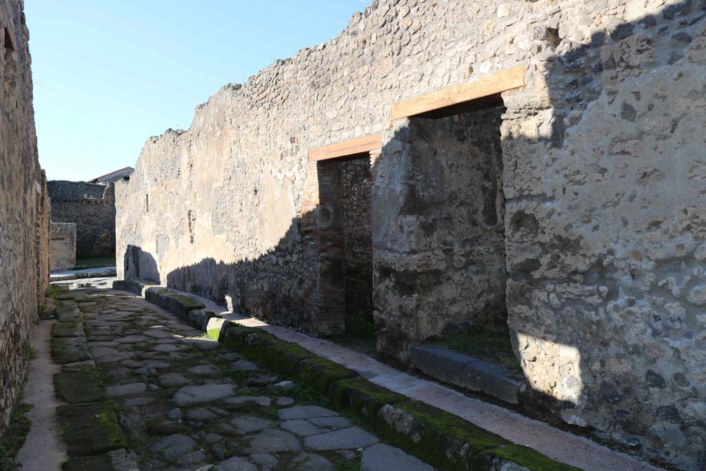 IX.2.13 Pompeii. December 2018. 
Looking west towards entrance doorway, left of centre, on north side of Vicolo di Balbo. Photo courtesy of Aude Durand.
