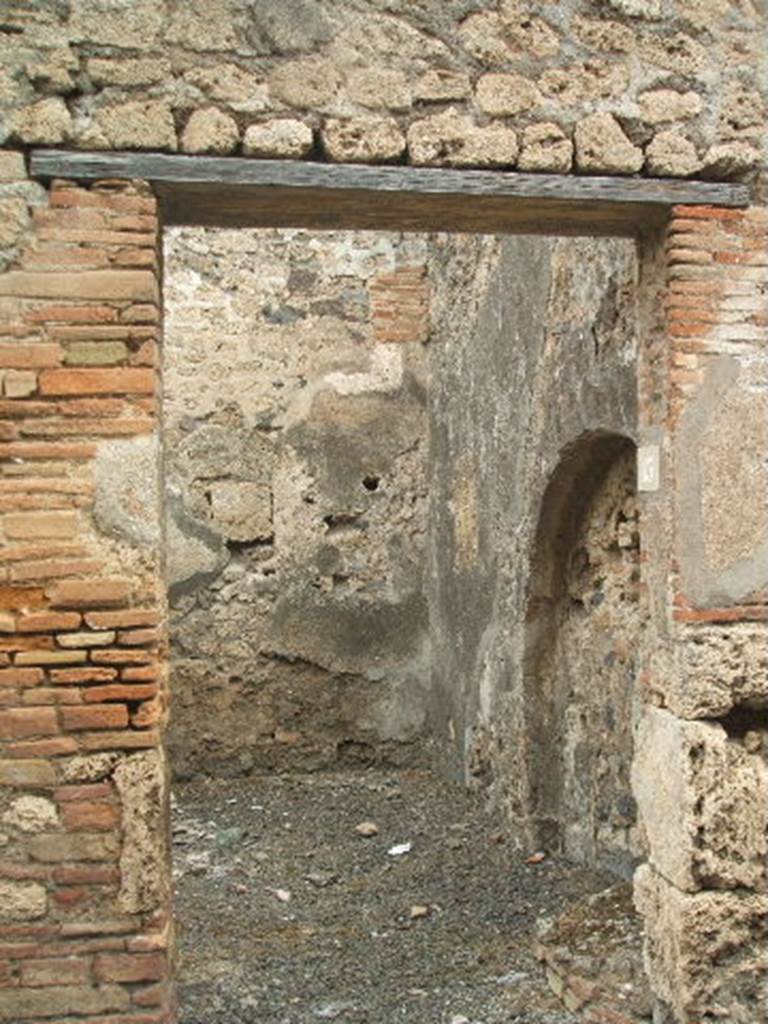 IX.2.13 Pompeii. May 2005. Looking north through entrance doorway, leading into two rooms with steps to upper floor. 

